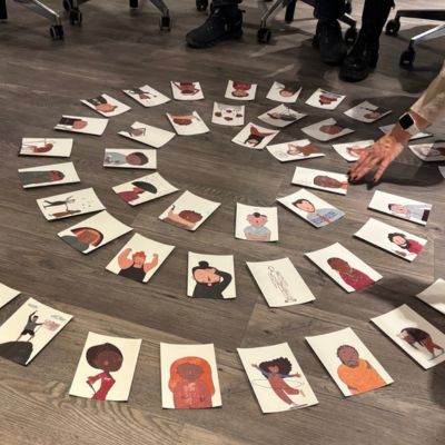 49 Gefühlskarten für Erwachsene in einer Spirale auf dem Boden in einem Workshopraum.